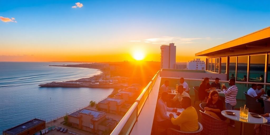 View from Dar es Salaam rooftop bar: city, ocean, sunset.